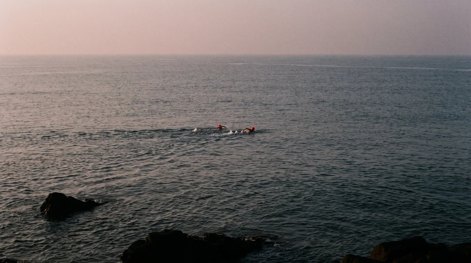 Open water off the Mumbai coast before sunrise, the surface almost flat.